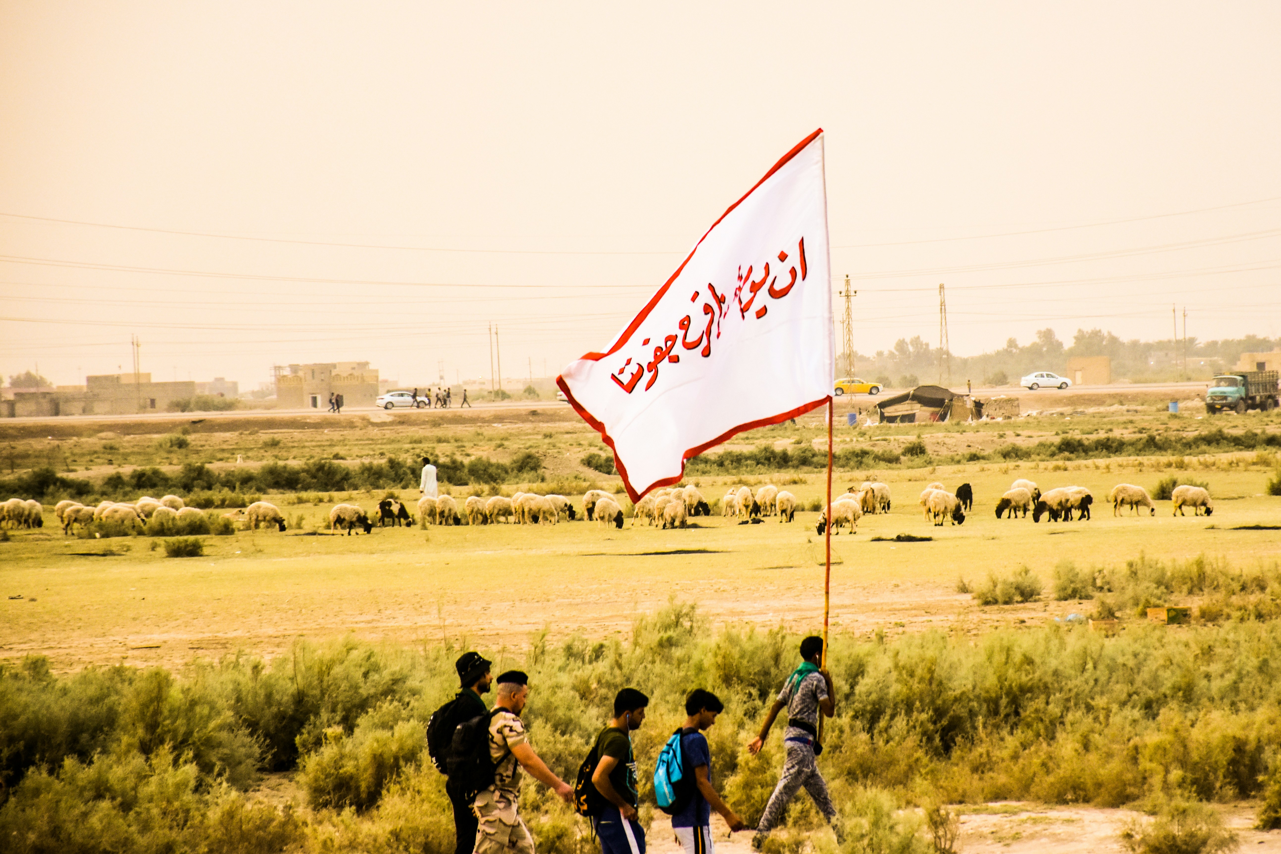 man holding white and red flag during daytime