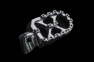 Precision 3D printed mechanical parts displayed on a sleek black surface.