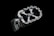 A close-up image of a metallic, machined part with a geometric design and bolts around the edges, placed against a black background.