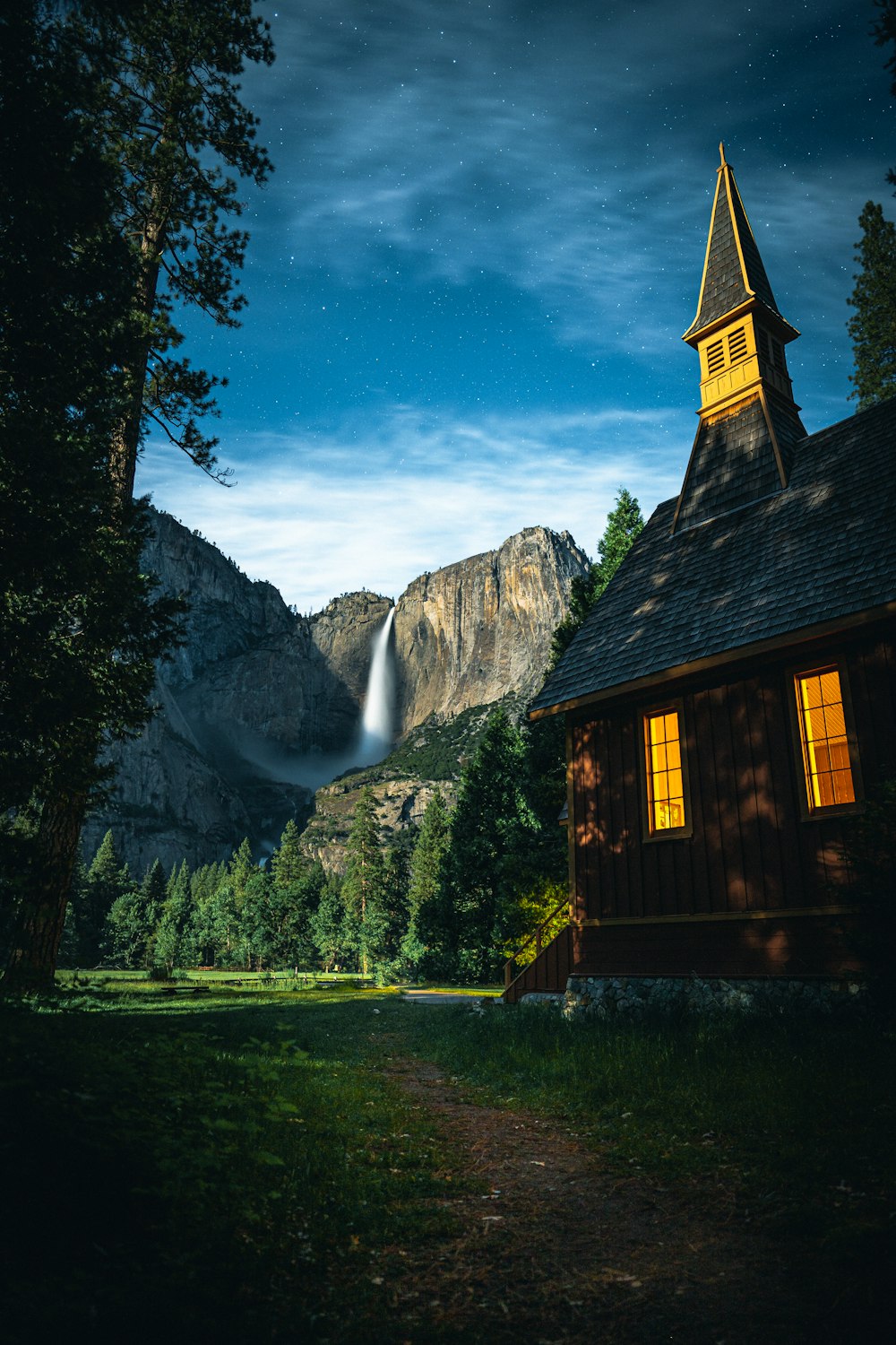 church near trees and waterfalls during day