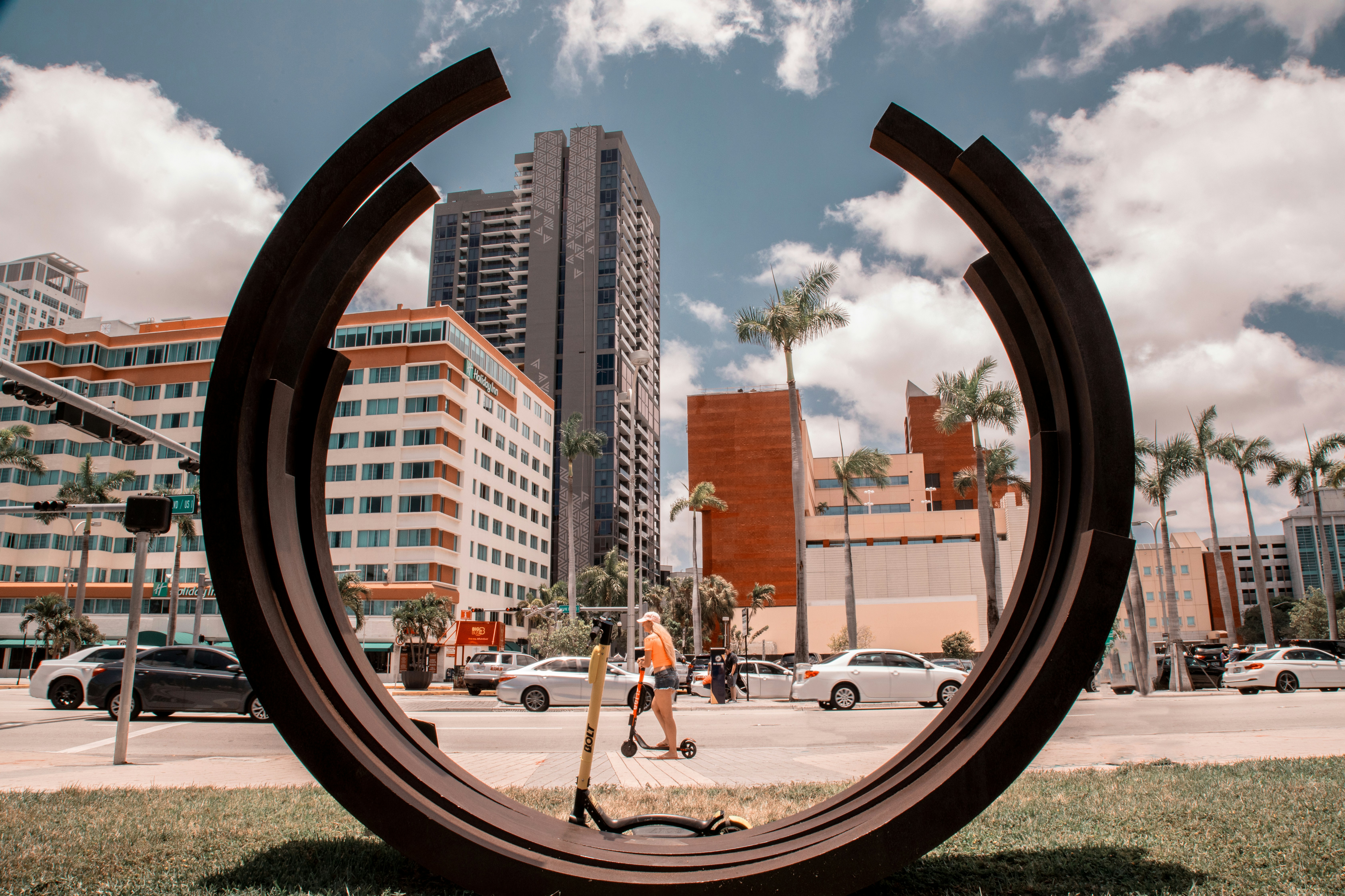 woman playing kick scooter near road during daytime