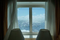 A professional consultant reviewing charts with a client, ocean visible outside.