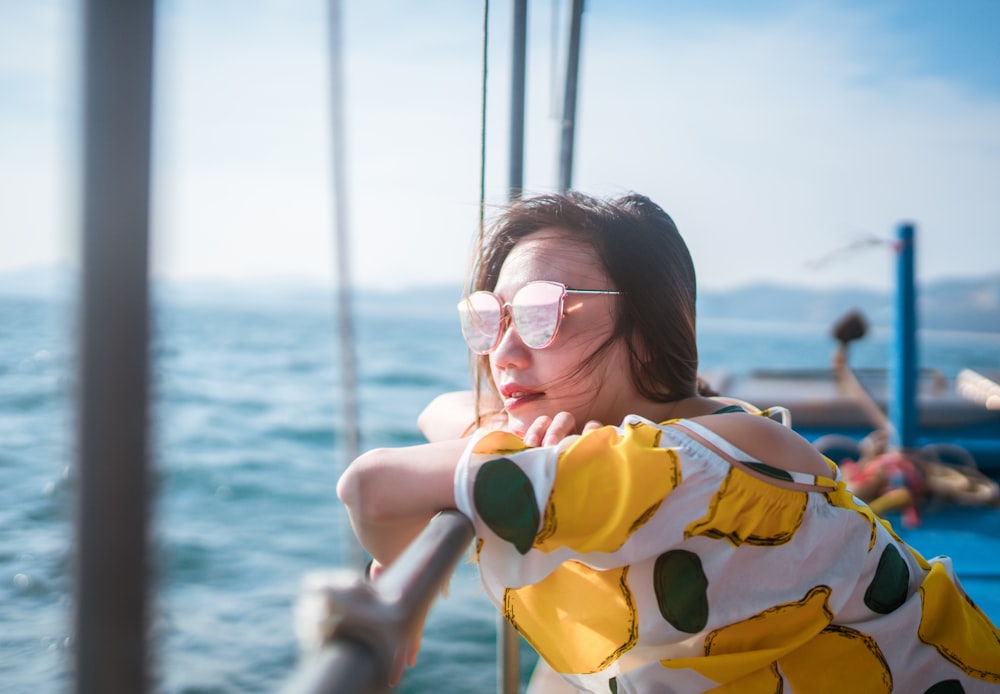 woman in sunglasses leaning on railings