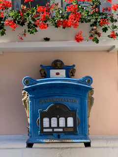 A pastel-colored illustration of a vintage mailbox surrounded by blooming flowers and soft gradients.