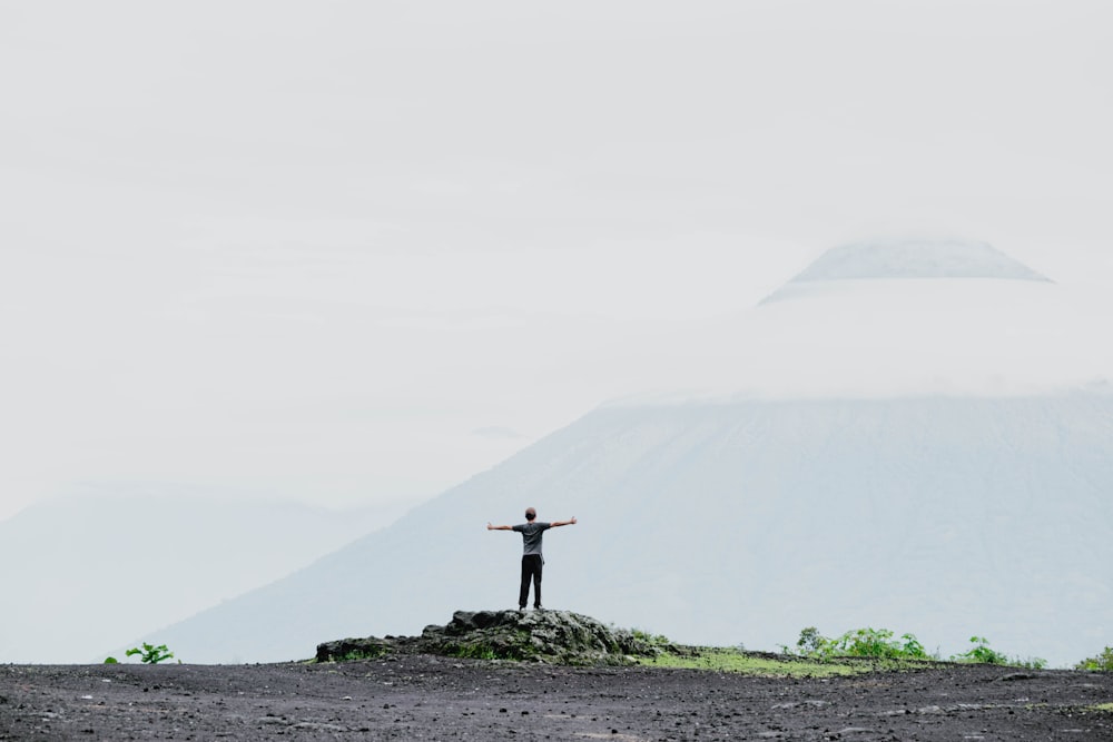 man standing in front of mountain during daytime