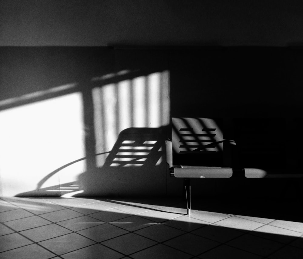 a black and white photo of a chair in a room