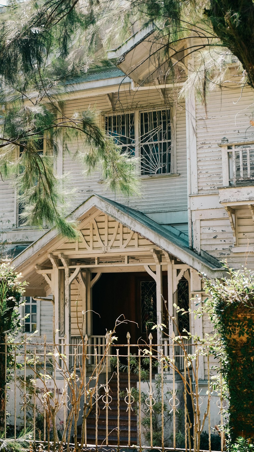 photo of wooden 2-storey house during daytime