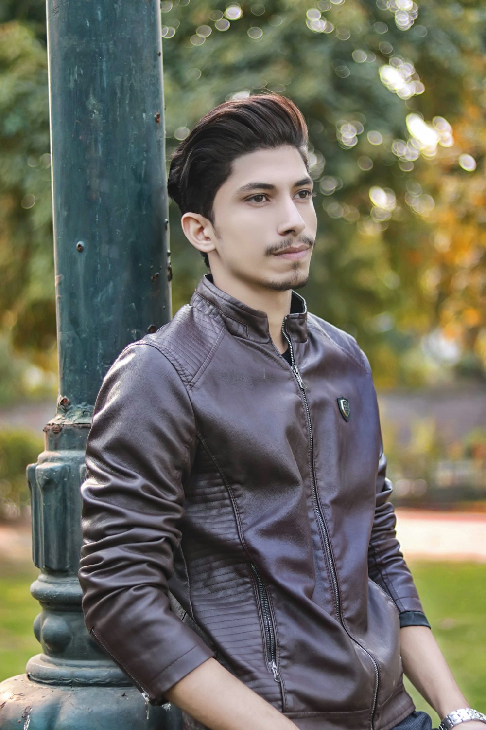 man wearing brown leather zip-up jacket selective focus photography