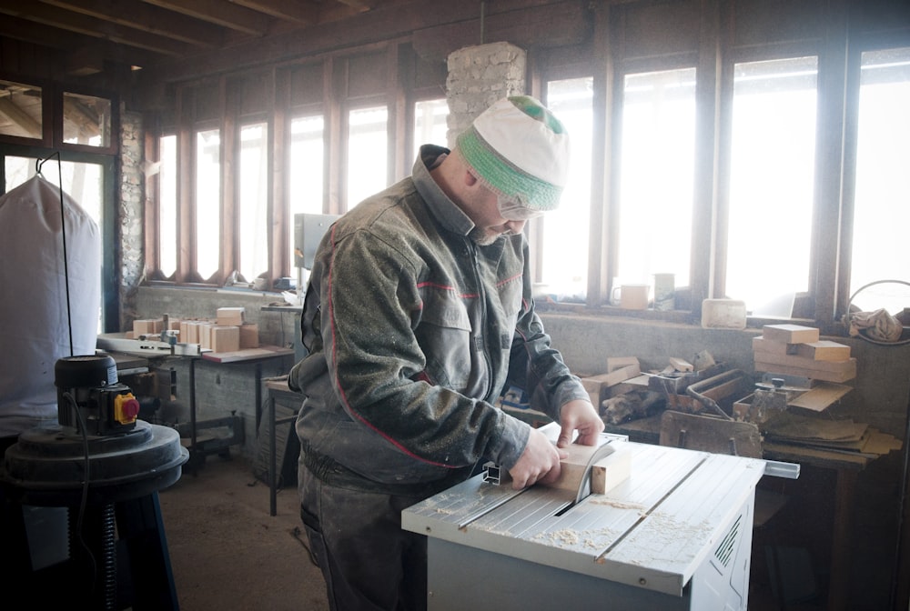 unknown person using table saw indoors