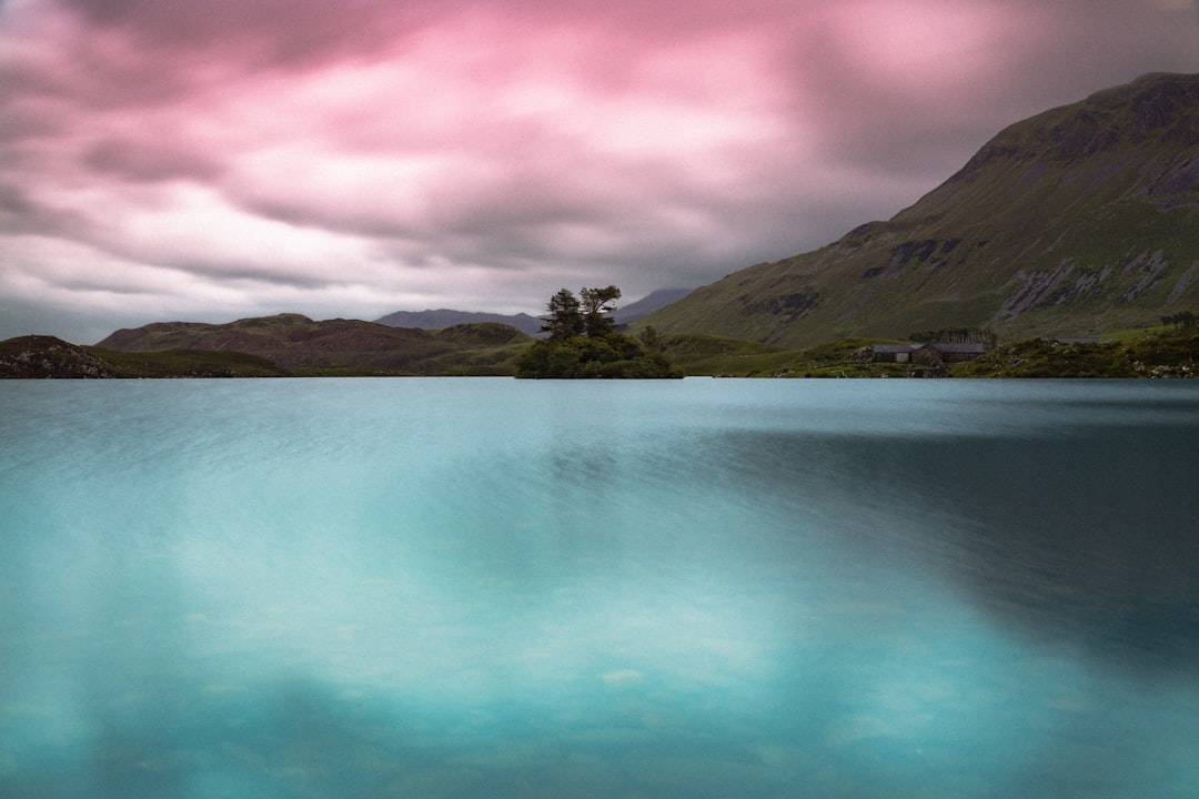 calm body of water and mountain