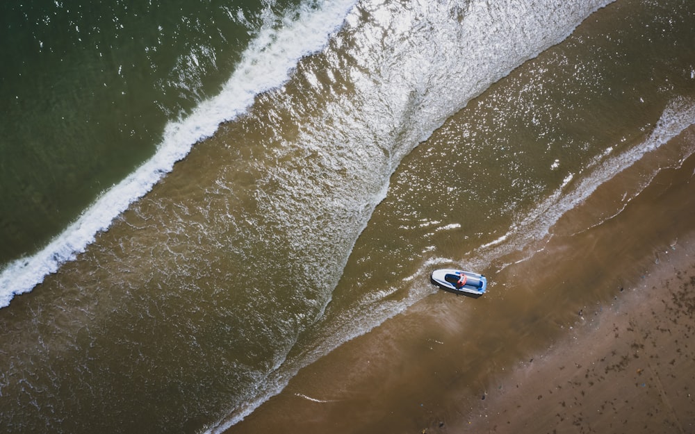 top-view photography of boat in sea during daytime