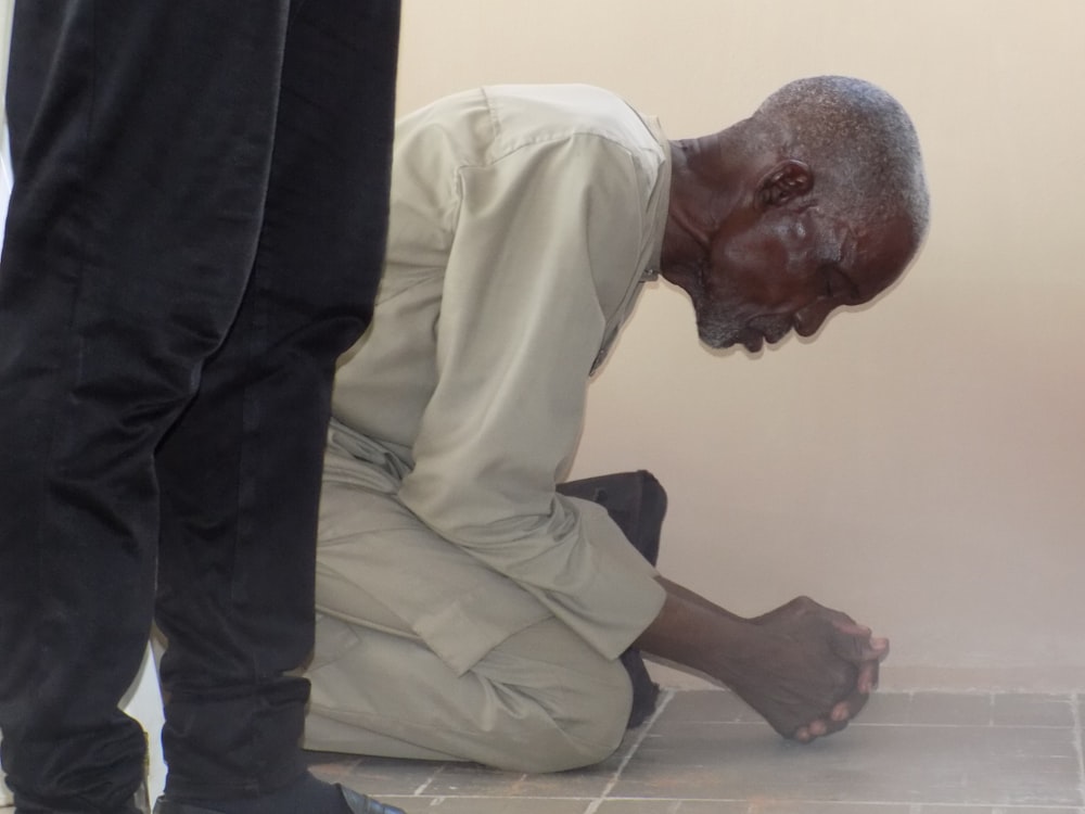 man kneeling and praying