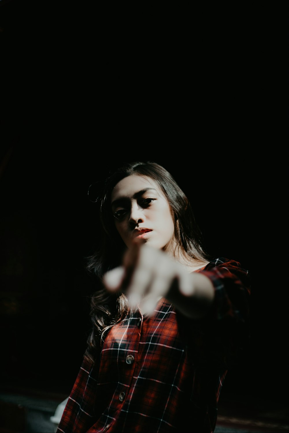 woman wearing red and black plaid top