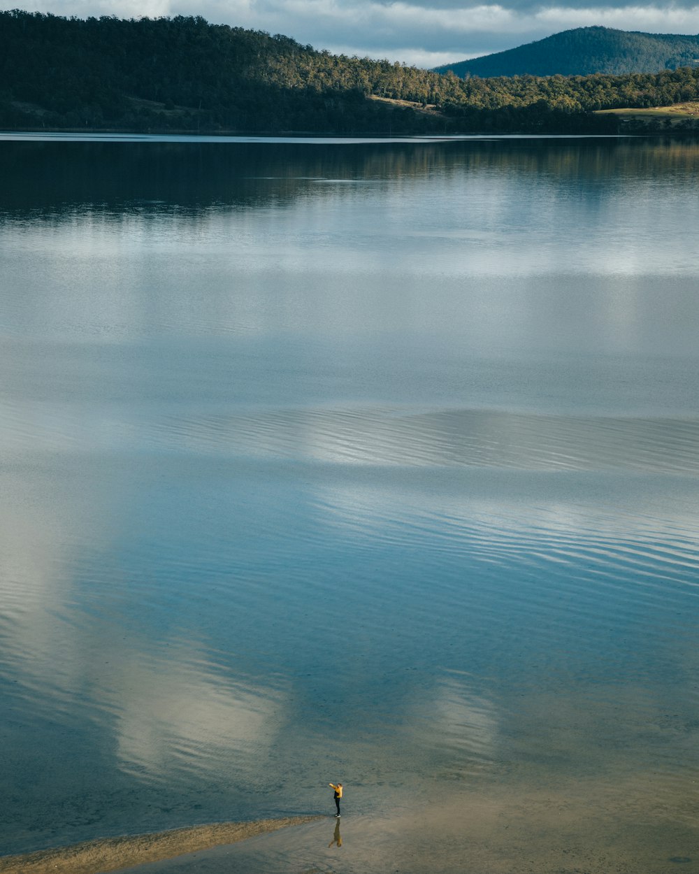 green mountains and body of water during daytime