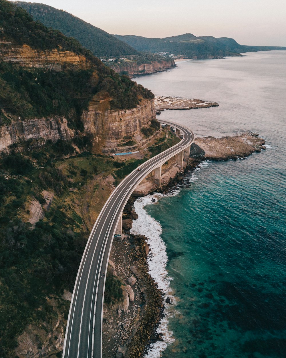 aerial photography of road beside sea