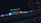 A close-up of a MacBook Pro laptop screen displaying several application icons on the dock. The highlighted application is Adobe Photoshop CC 2017, accompanied by other software icons like Lightroom and Illustrator. The cursor is pointing at the Photoshop icon.
