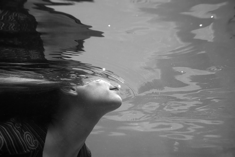 grayscale photography of woman in water