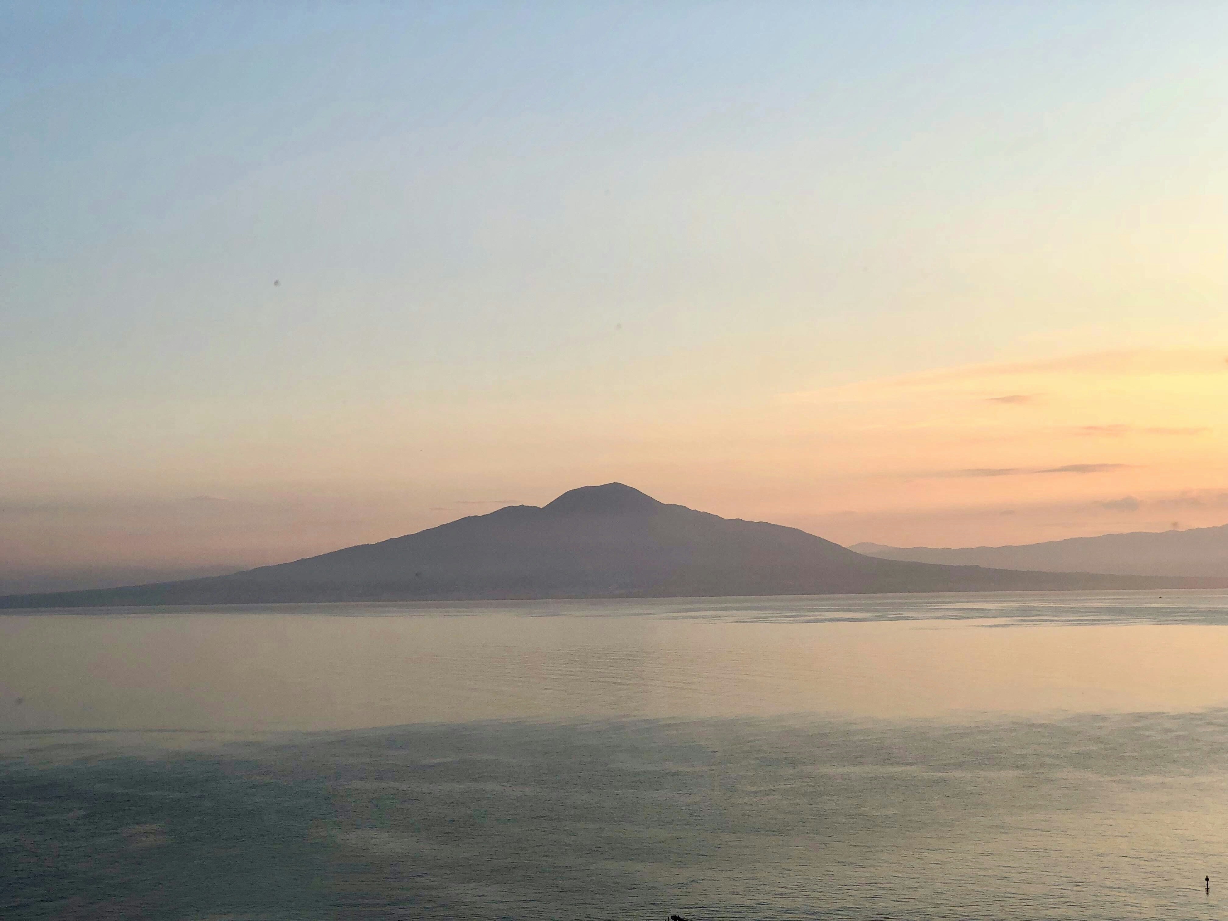 brown hill across bay, Looking across the Bay of Naples from Maison La Minervetta l in Sorrento Italy, towards Mount Vesuvius as the Sun begins to rise. Such a beautiful scene. This photo makes me feel calm and relaxed and I would really like to re visit this place one day