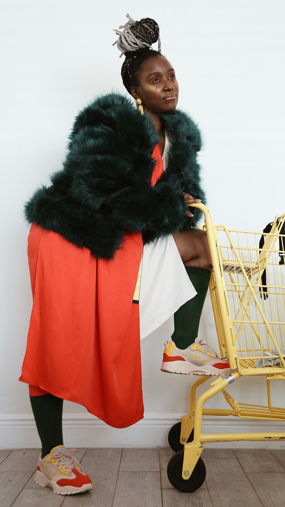 woman leaning on yellow grocery cart