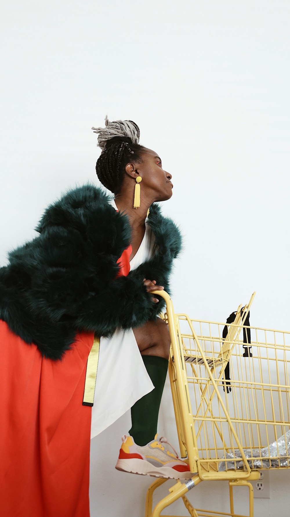 woman wearing black fur coat and red dress