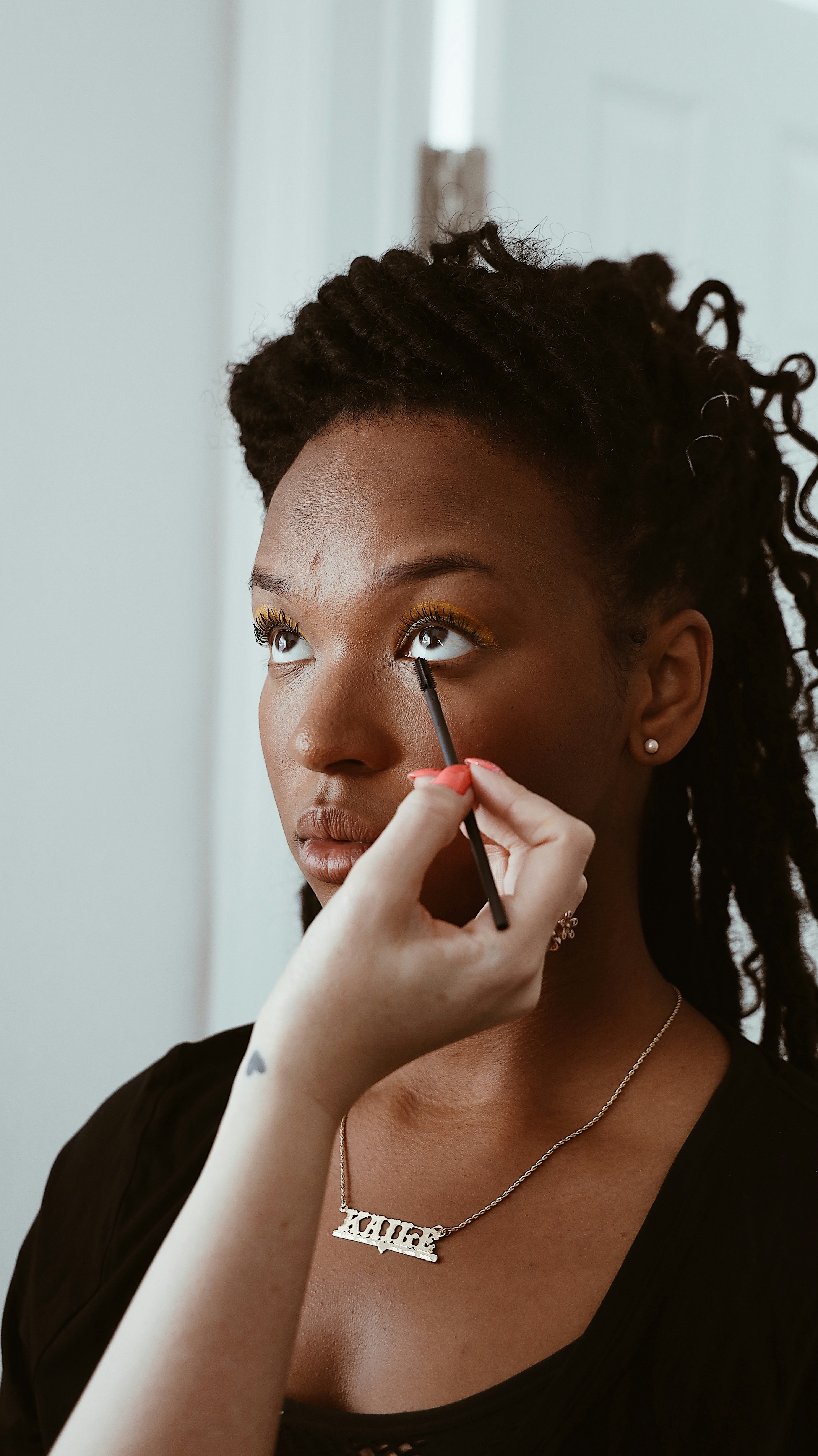 woman wearing black scoop-neck sweater