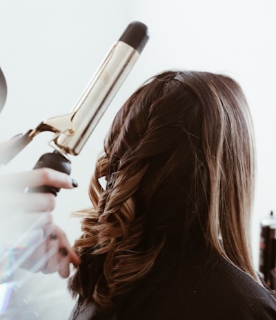 person holding gray hair curler