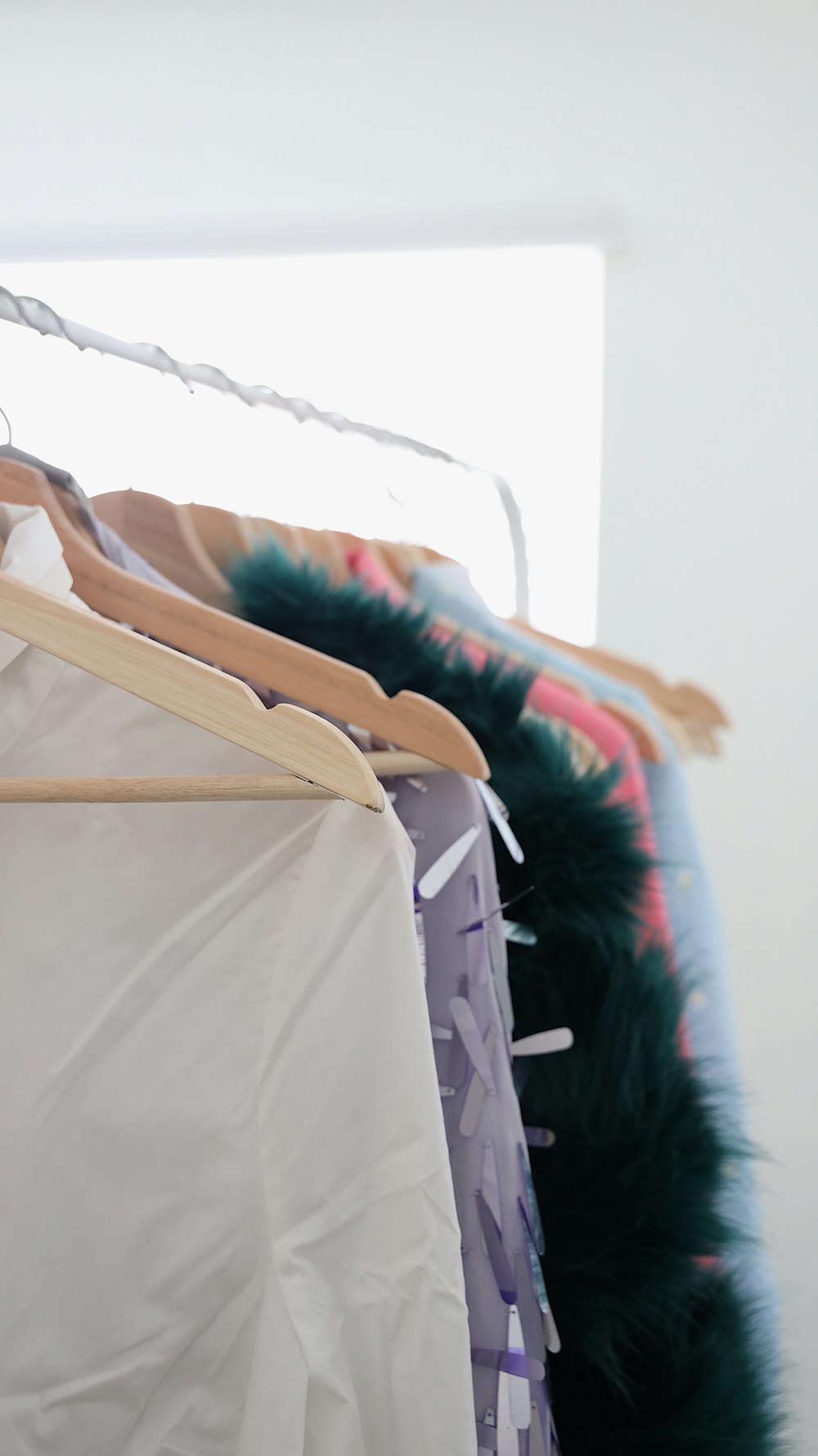 assorted garments hanging on rack