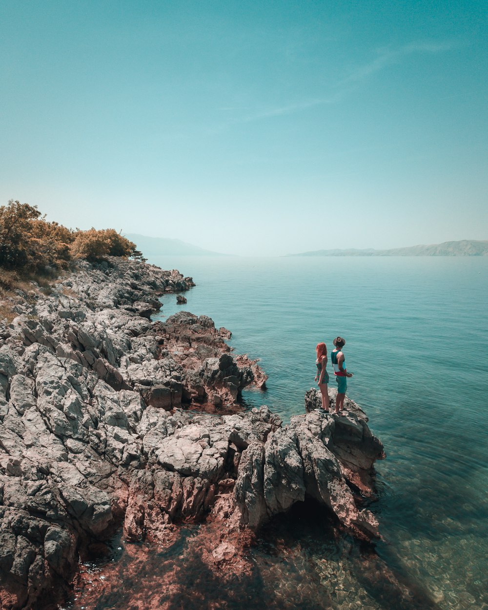 man and woman on rock