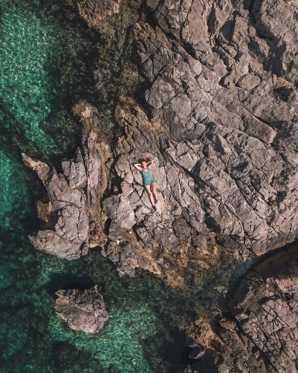 woman lying on rocks