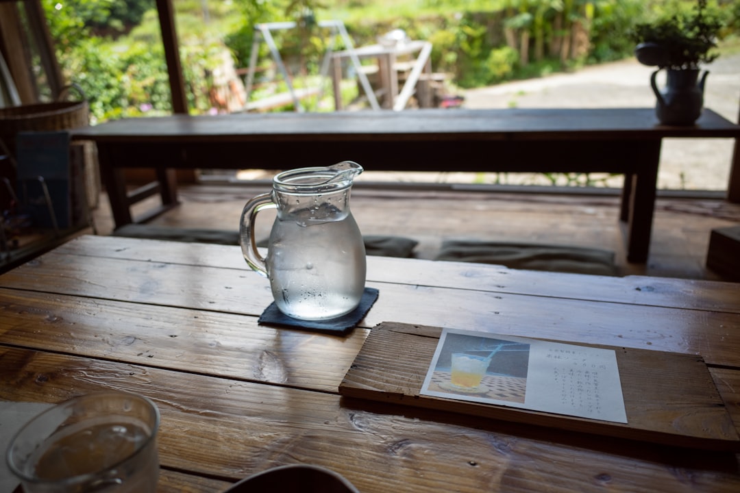 water in clear glass pitcher on table