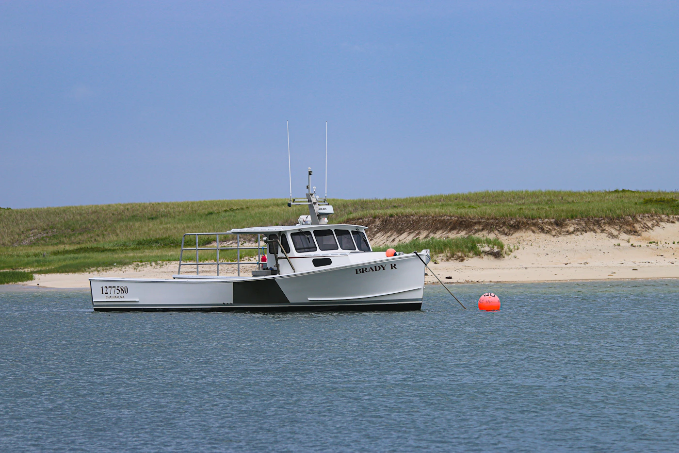 A working commercial fishing boat on calm water, representing the seaman status that unlocks Jones Act damages