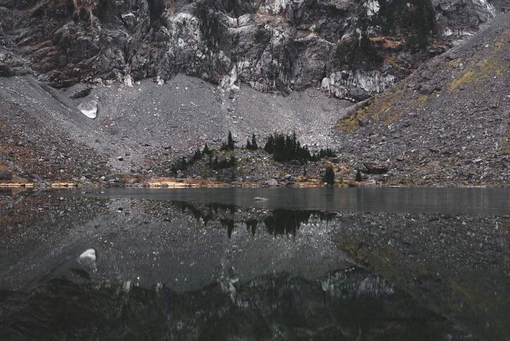 river beside grey cliff