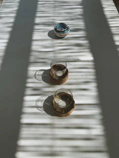 Evening scene with gentle shadows cast by a crystal bowl and flickering candle flames.