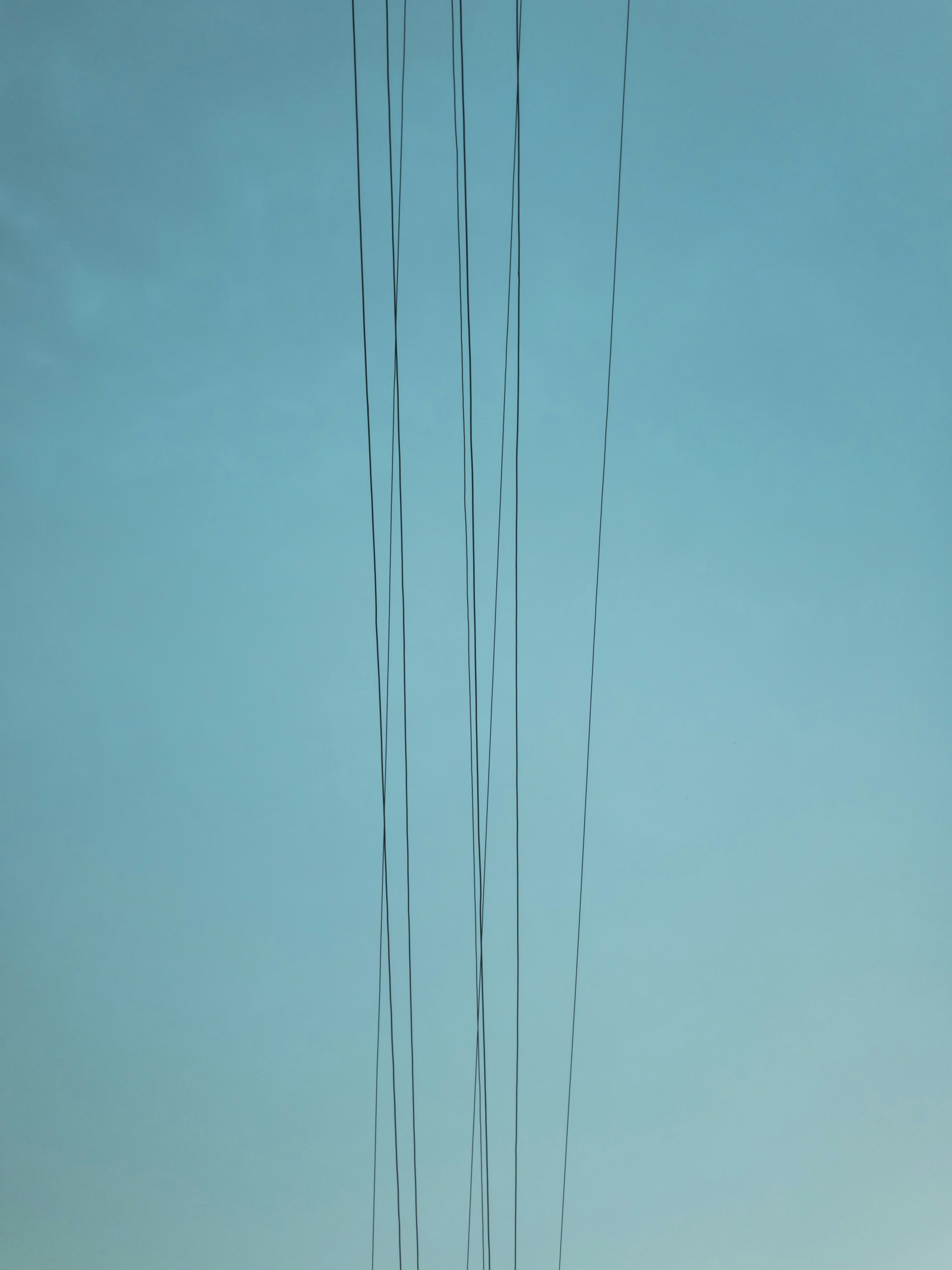 several cables under clear green sky