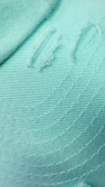 A close-up of mint green fabric draped elegantly.