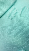 Close-up of soft fabric and trendy font detail on a mint green hygiene tee.