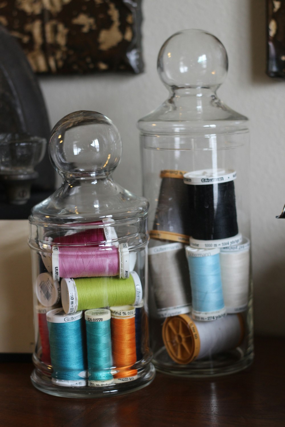 two clear glass jars with threads
