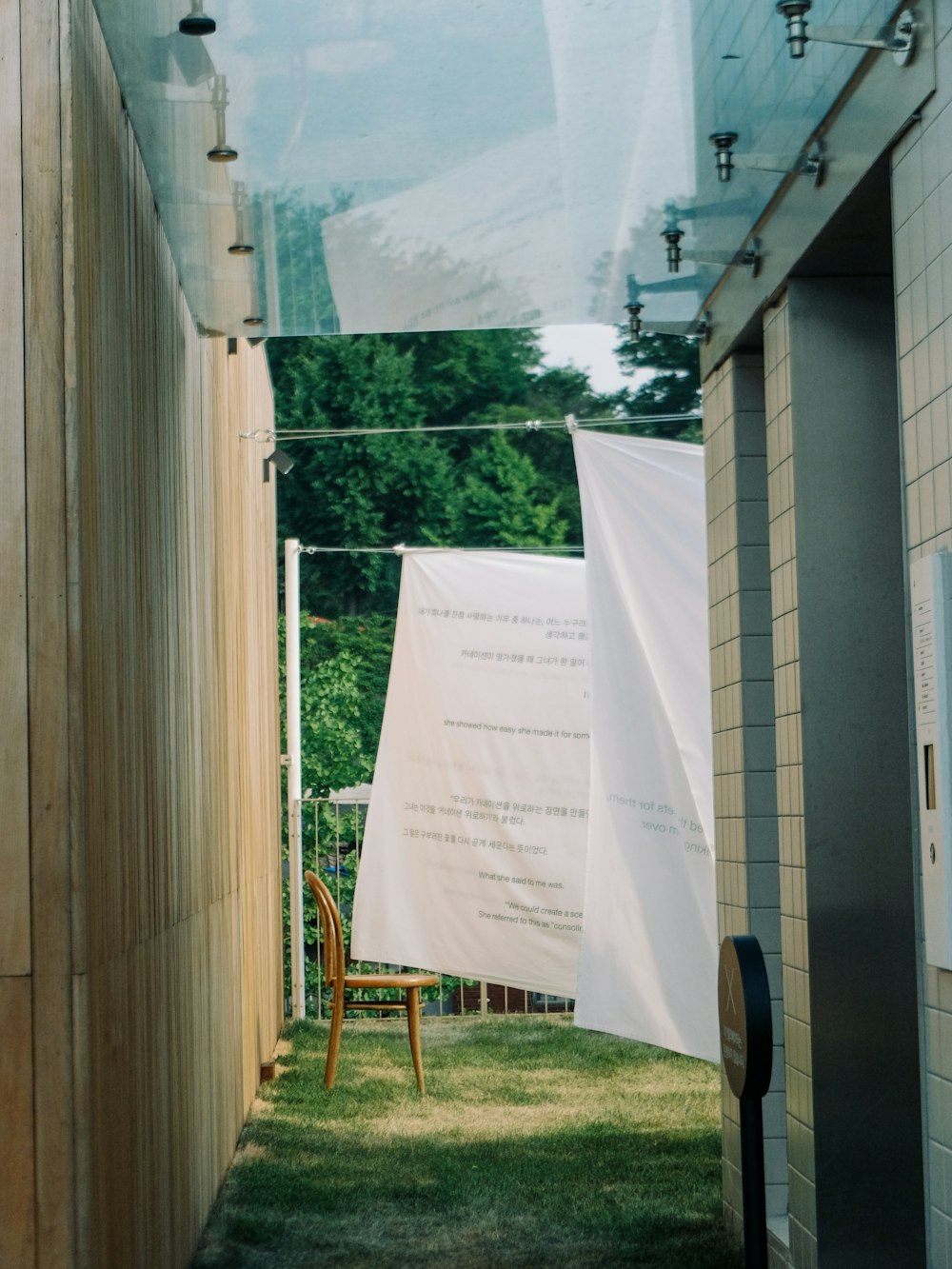 white and gray blanket hanging outside house