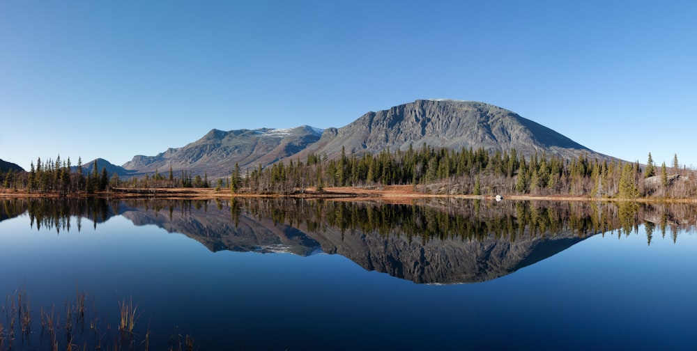 body of water near a mountain during daytime