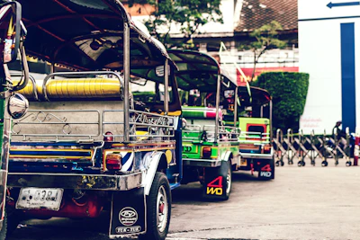 Colorful tuk-tuks lined up on a lively street in Hanoi.