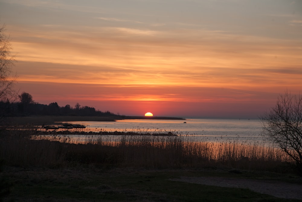 orange setting sun over sea