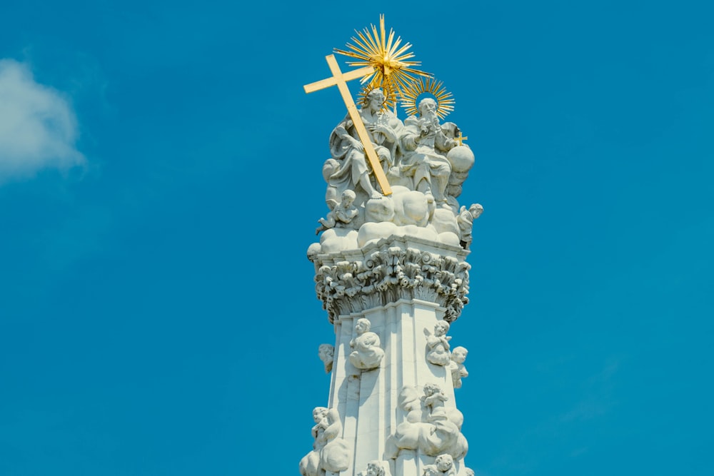 brown cross on white concrete tower during daytime