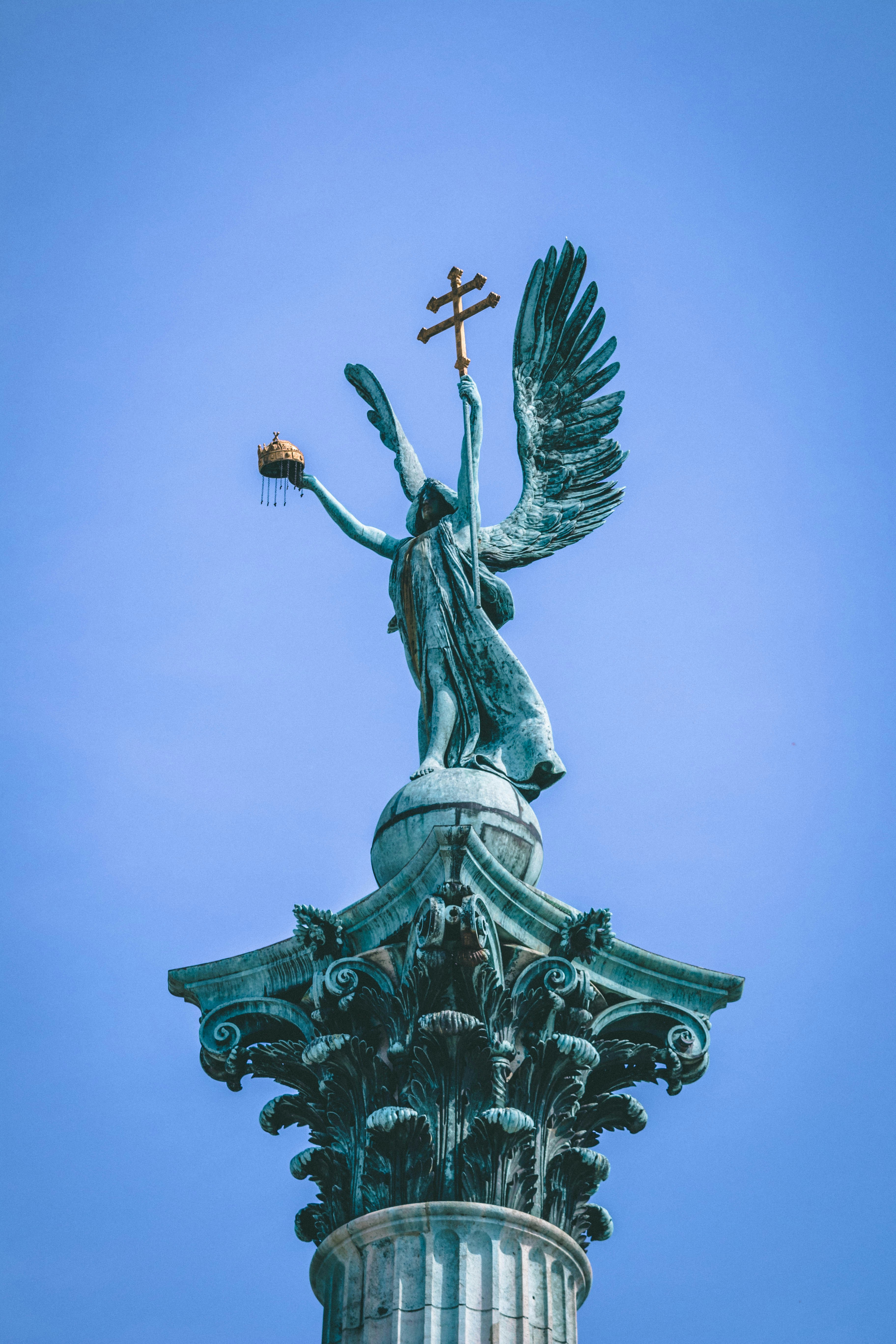 winged angel concrete statue during daytime