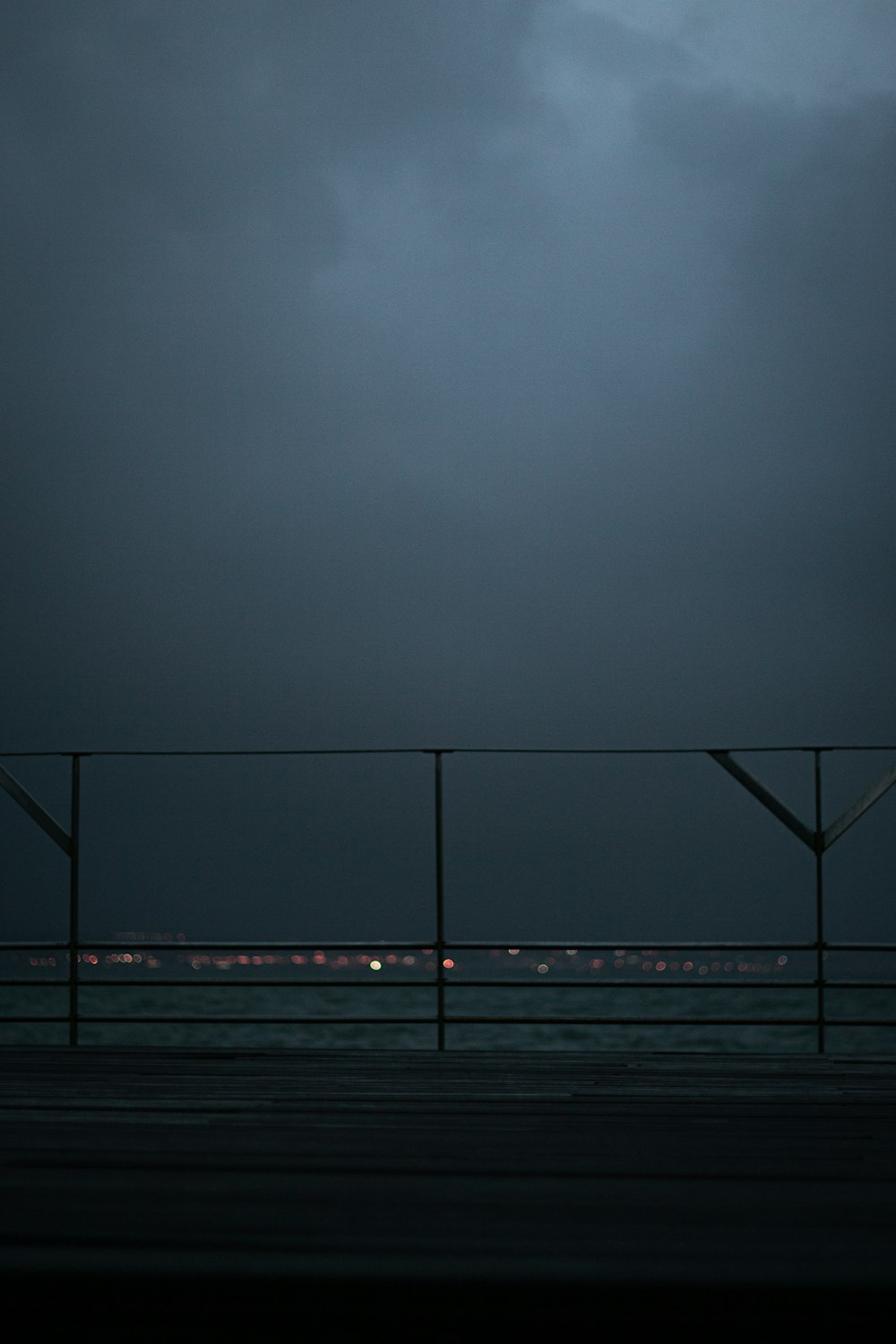 gray metal fence near ocean