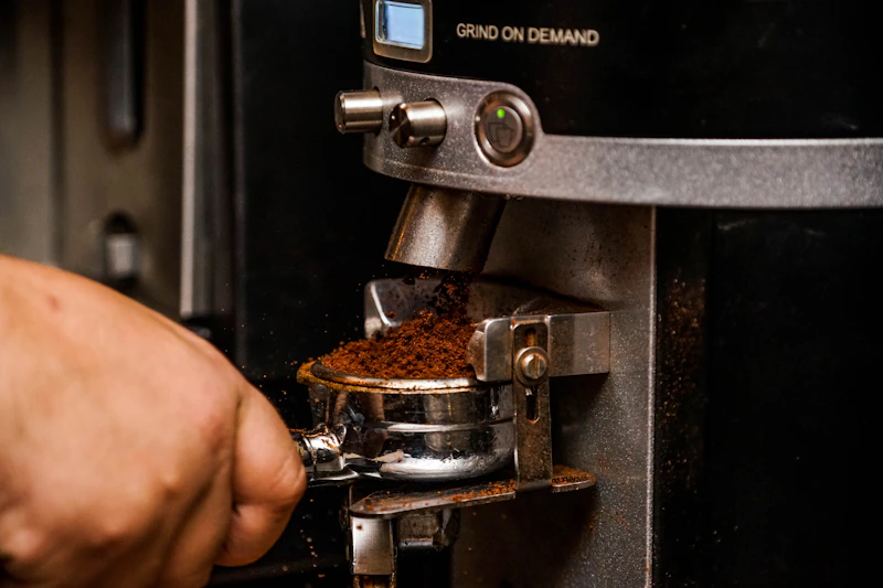 Black espresso machine brewing a shot