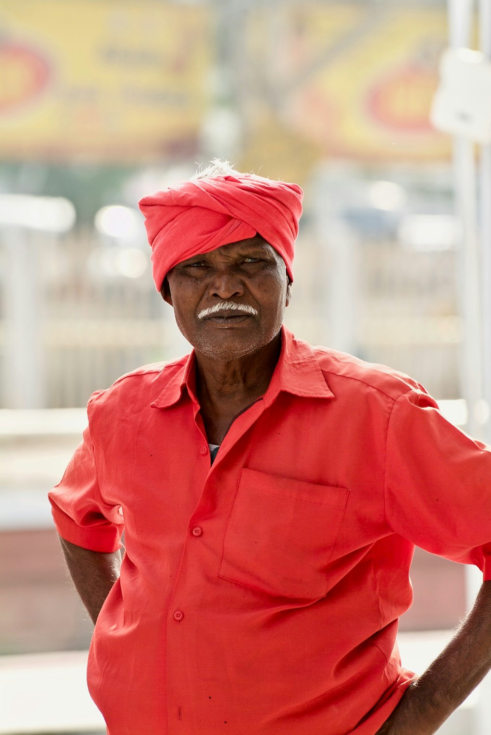 person wearing a red turban during daytime close-up photography