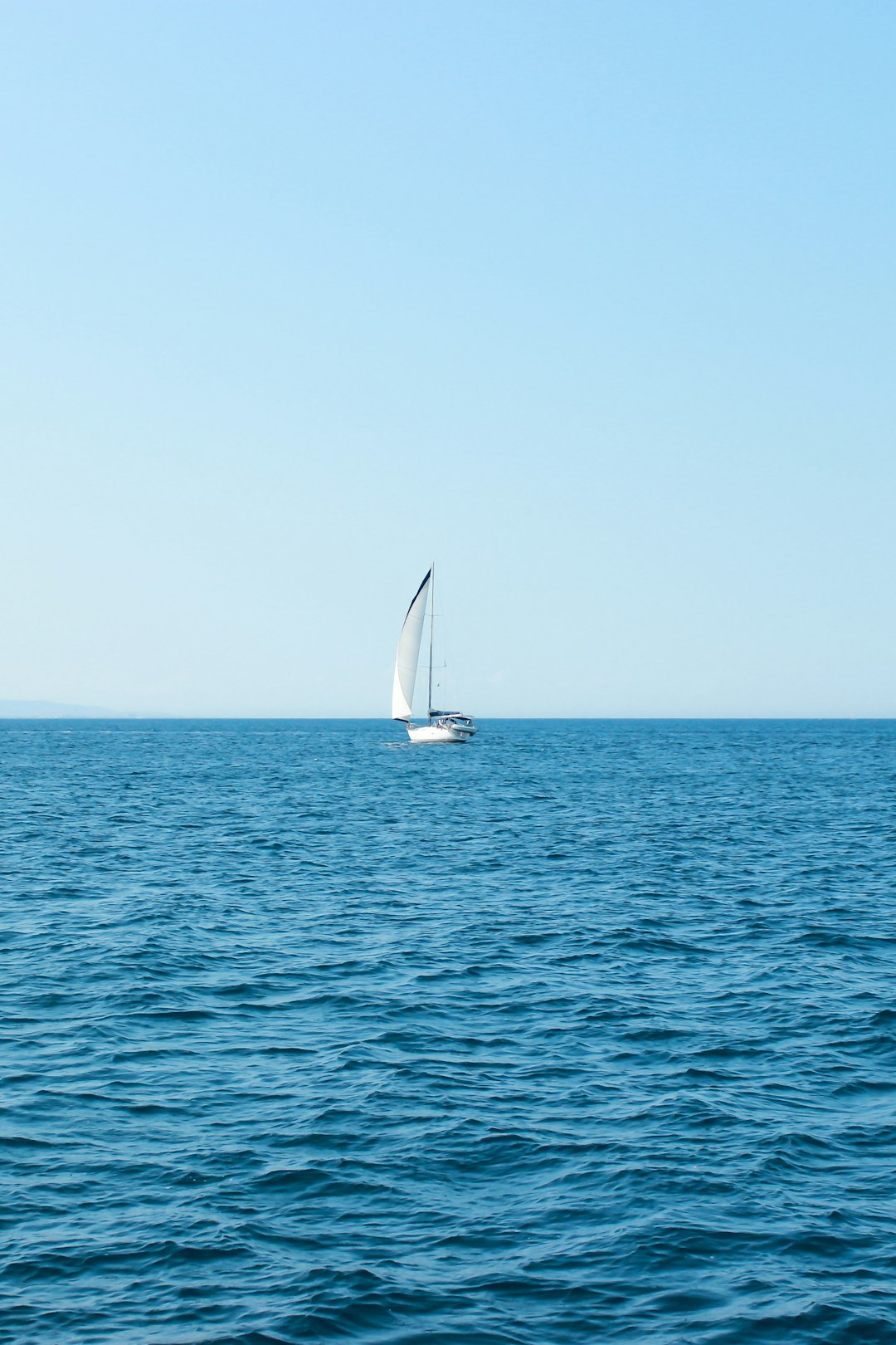 photography of sailboat traveling during daytime