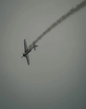 L39 Albatros performing a sharp maneuver at dusk.