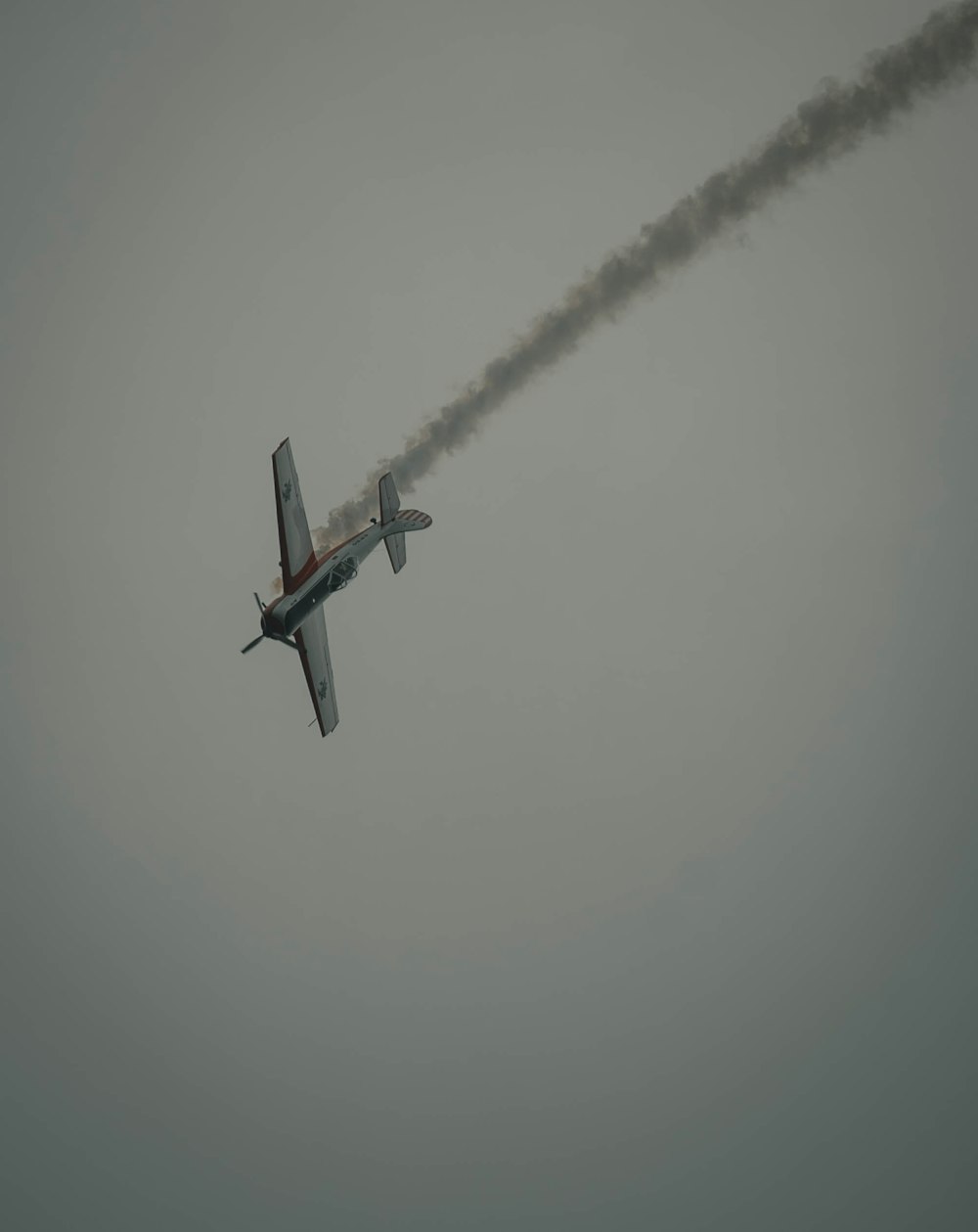 photography of crashing biplane during daytime