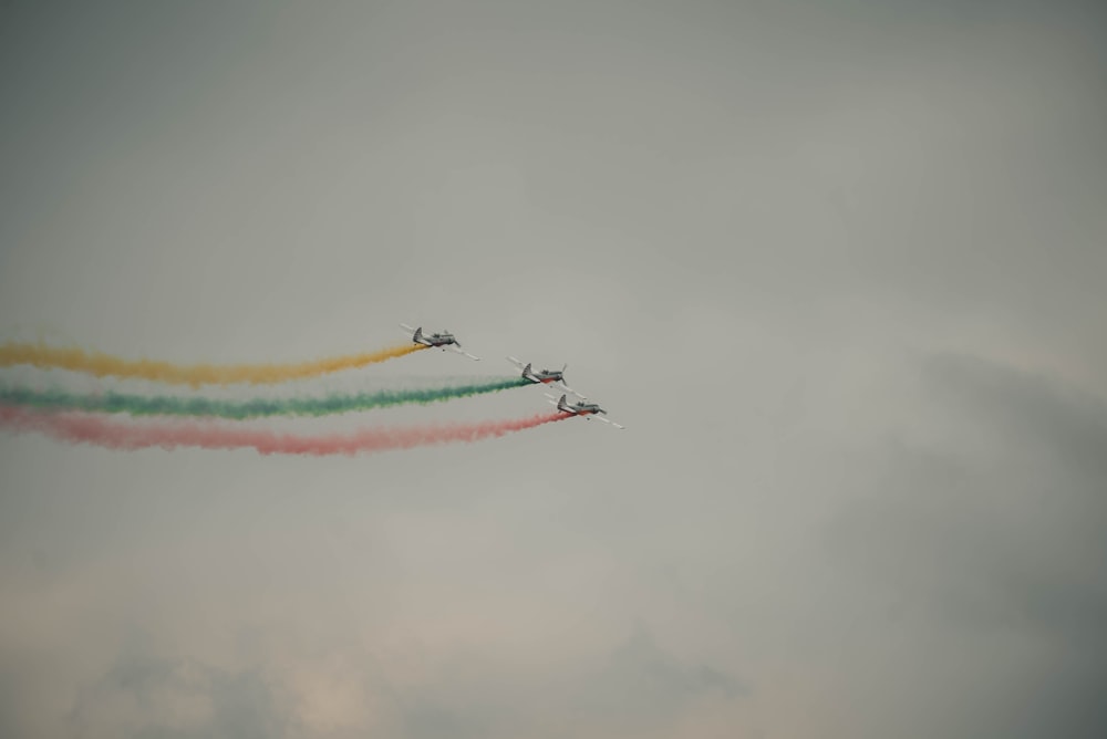 three fighter jets under gray clouds